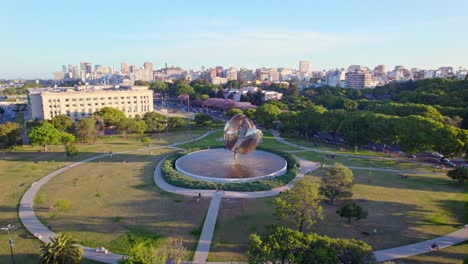Aerial-view-establishing-the-Floralis-Generica-and-the-United-Nations-park-in-the-Recoleta-neighborhood,-residential-buildings-in-the-background