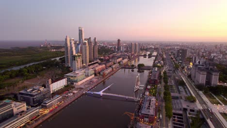 Dolly-in-aerial-view-of-the-Dique-River-with-the-luxurious-skyscrapers-and-the-museum-ship-frigate-A