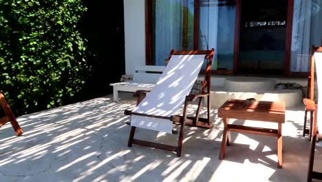 Panning-shot-of-hammock-chairs-outside-a-resort-in-Kiwengwa,-Tanzania