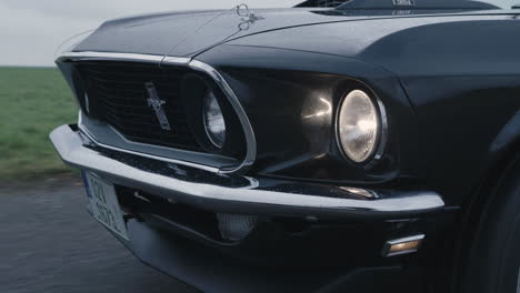 Close-Up-of-Ford-Mustang-Mach-1-Front,-Classic-Sport-Car-Moving-on-Road