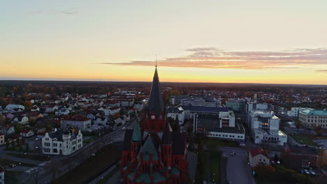 Vastervik,-Sweden-sunset-cityscape-downtown-area---aerial-pull-back-reveal