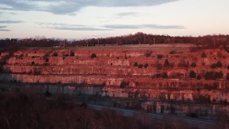 Slow-aerial-trucking-pan-of-upper-Cove-Spring-Park-in-Frankfort,-Kentucky-during-the-sunset-golden-hour