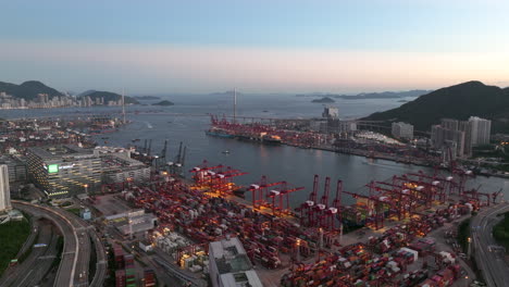 Giant-container-port-illuminated-by-terminal-lights-after-sunset-on-a-clear-day