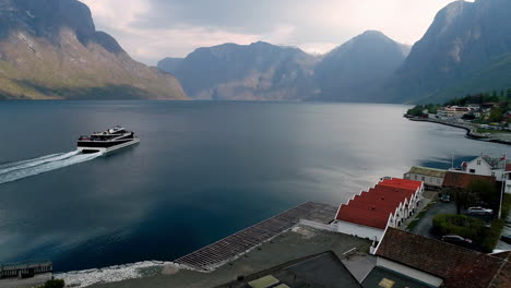 Aerial-following-shot-of-modern-cruiser-cruising-on-Norwegian-Fjord-during-cloudy-day---Panorama-shot