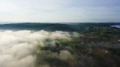 Slow-aerial-trucking-shot-of-farmland-in-Kentucky-with-low-sitting-cloud-layers
