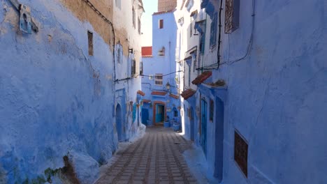 View-Looking-Up-At-Half-Blue-Painted-Wall-In-Chefchaouen-With-Tilt-Down-To-Reveal-Empty-Street