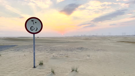 60-km-speed-limit-road-sign-in-the-middle-of-the-Arabian-desert-at-sunset