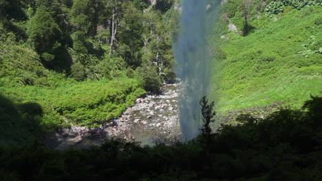 Santa-Ana-waterfall-seen-from-cave,-people-admiring