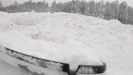 Shovelling-fresh-snow-from-driveway-after-blizzard,-POV
