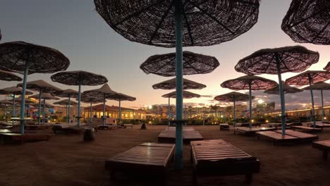 Timelapse-of-the-Sunset-on-the-Beach-With-Umbrellas-and-Beach-Chair-With-Sea-Beach-Background-Pool-by-Amazing-Sunset-View