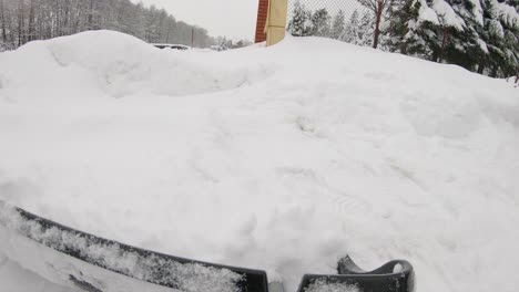 POV-man-shovelling-snow-from-driveway-after-heavy-snowfall