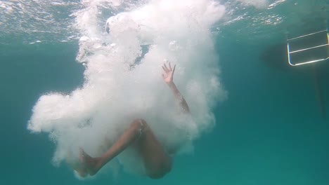 Girl-jumps-into-the-water-from-a-yacht,-slow-motion-underwater-viewing