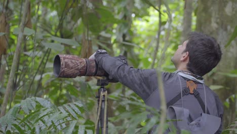 Professional-wildlife-photographer,-camera-in-hand-big-lens-in-Jungle-Forest