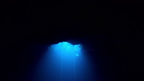 mirror-reflection-in-a-cave-when-a-freediver-escending-from-the-surface