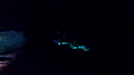 Cave-divers-in-a-dark-underwater-cave-called-a-cenote-in-Mexico
