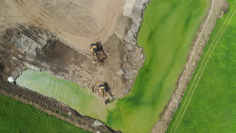 Aerial-shot-of-heavy-machinery-on-construction-site-quarry-in-Europe