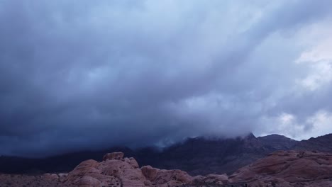 Gimbal-panning-shot-across-thick-dramatic-clouds-in-Red-Rock-Canyon,-Las-Vegas-in-low-light