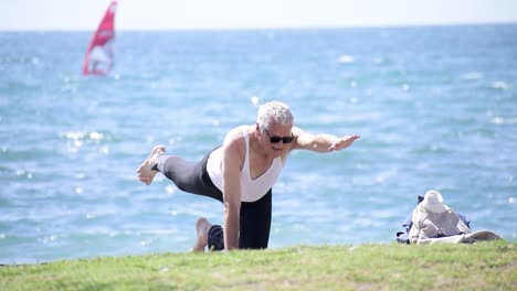 ältere-Menschen,-Die-Am-Strand-Yoga-Machen