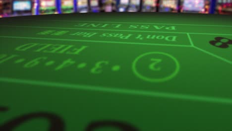 Pair-of-dice-thrown-onto-a-craps-or-crapaud-table-with-glittering-poker-machines-in-a-casino-background---craps-throws---translucent-red-dice-throw-of-a-pair-of-fives