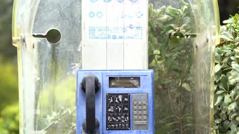 Haifa-Israel-jan-13-2023:-old-broken-payphone,-blue-pay-phone-that-belongs-to-Bezeq-telecommunications-company