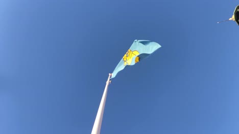 Flag-of-Stockholm,-capital-city-of-Sweden,-waving-in-the-blue-sky