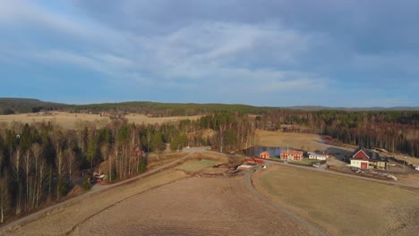Drone-shot-of-farm-in-Sweden-at-winter-but-without-snow