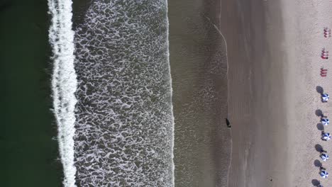 Aerial-view-above-the-Barra-Do-Sahy-beach,-in-sunny-Brazil---cenital,-drone-shot