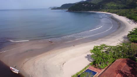 Aerial-view-overlooking-the-Barra-Do-Sahy-beach,-in-sunny-San-Sebastian,-Brazil