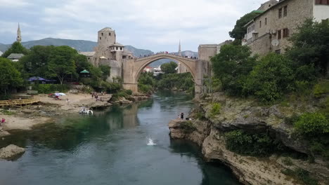 Man-does-backflip-dive-off-high-platform-near-Mostar-old-bridge-Bosnia