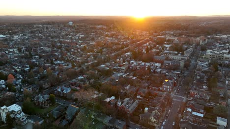 Backwards-reveal-of-sprawling-city-neighborhood-during-winter-sunset
