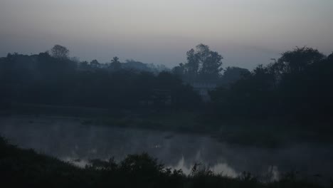 sun-rise-behind-tree-near-the-hot-water-spring-river-fog-on-water-mist-in-air-cold-morning