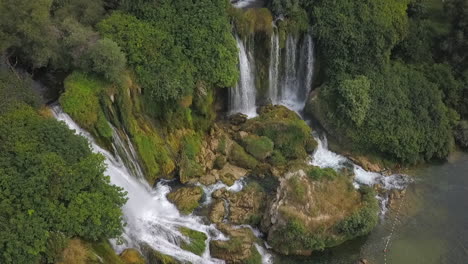 Rotating-aerial-view-of-stunning-Kravice-waterfall-in-Studenci,-Bosnia