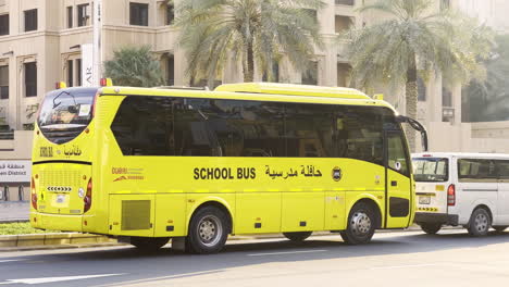 Arabian-yellow-school-bus-in-traffic-waiting-for-kids-in-Dubai-city