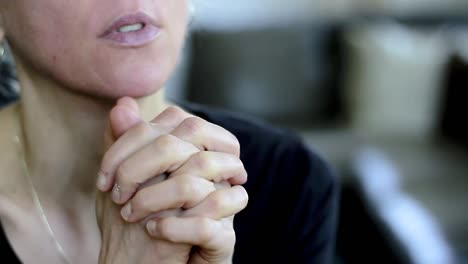 Betende-Frau-Mit-Der-Hand-über-Ihrem-Gesicht-Auf-Grauem-Hintergrund-Mit-Menschen-Stockvideo