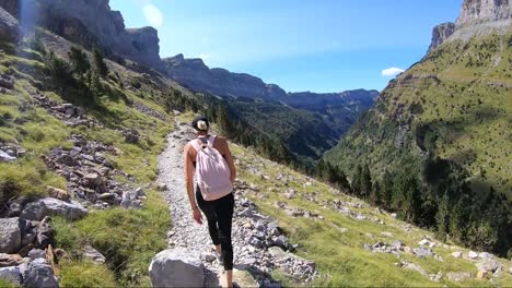 Hiker-walking-on-the-slopes-of-the-Ordesa-Valley-in-the-Pyrenees-of-Huesca,-Spain