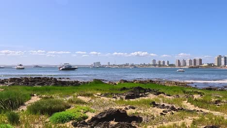 Skyline-of-Punta-del-Este-in-the-summer-with-yachts,-ocean-and-the-beach-in-front,-Uruguay