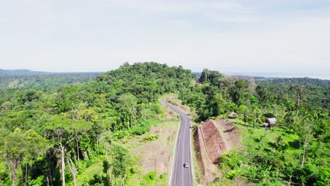 Drone-Flying-Over-Highway-and-Forests-in-Calovebora,-Panama