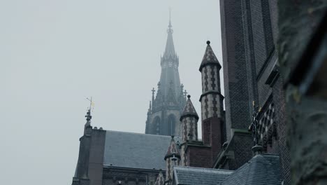 Slowmotion-shot-of-a-church-steeple-being-covered-by-the-incoming-fog-in-Rotterdam
