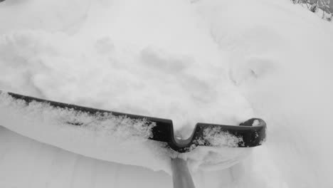 Removing-snow-from-pathway-after-blizzard,-pov-slow-motion