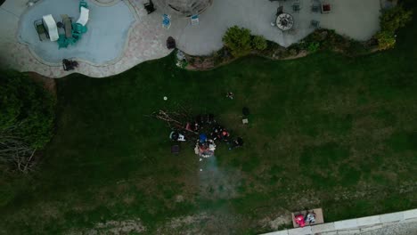 Top-drone-view-of-an-outdoor-picnic-party,-people-cheer-with-drinks