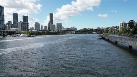 Flying-next-to-the-Brisbane-RiverWalk-towards-the-Story-Bridge-with-Brisbane-in-the-background