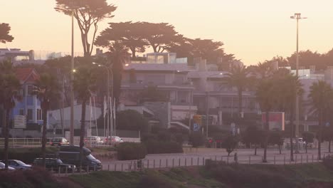 Silhouette-of-city-on-sunset-background-with-some-cars-driving-near-Cascais