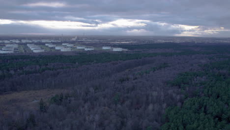 Aerial-view-of-forest-landscape-and-Fuel-Base-Storage-in-Gdansk-during-cloudy-day