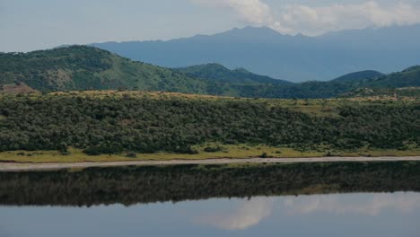 Lush-African-hillside-view-reflected-over-dam