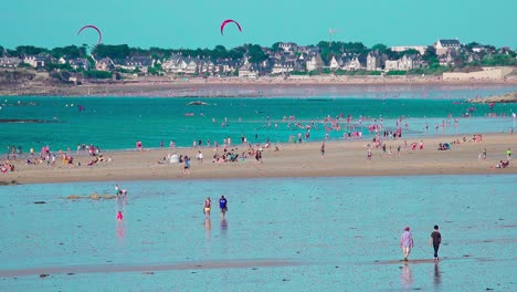 People-and-kitesurfers-enjoying-a-beautiful-and-sunny-day-at-the-beach-and-in-the-sea