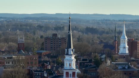 Aerial-zoom-of-three-church-steeples-in-American-city-during-winter