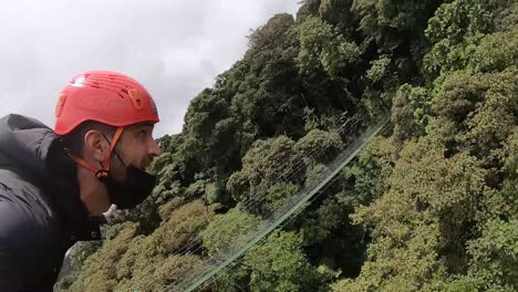 Man-flying-over-the-Costa-Rican-cloud-forest,-canopies,-extreme-adventure