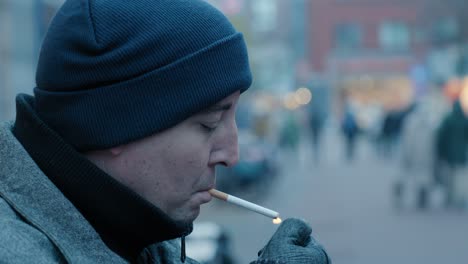 Close-up-shot-of-a-man-lighting-a-cigarette-in-the-streets-of-Rotterdam