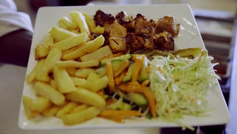 Beautiful-Plate-Presentation-Of-Grilled-Chicken,-French-Fries-And-Colslaw-Salad