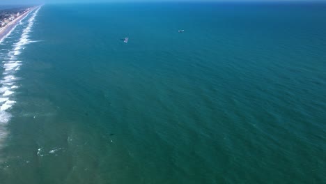 Plane-draging-a-advertisement-banner-over-the-coastal-sea-in-Florida,-USA---Aerial-view